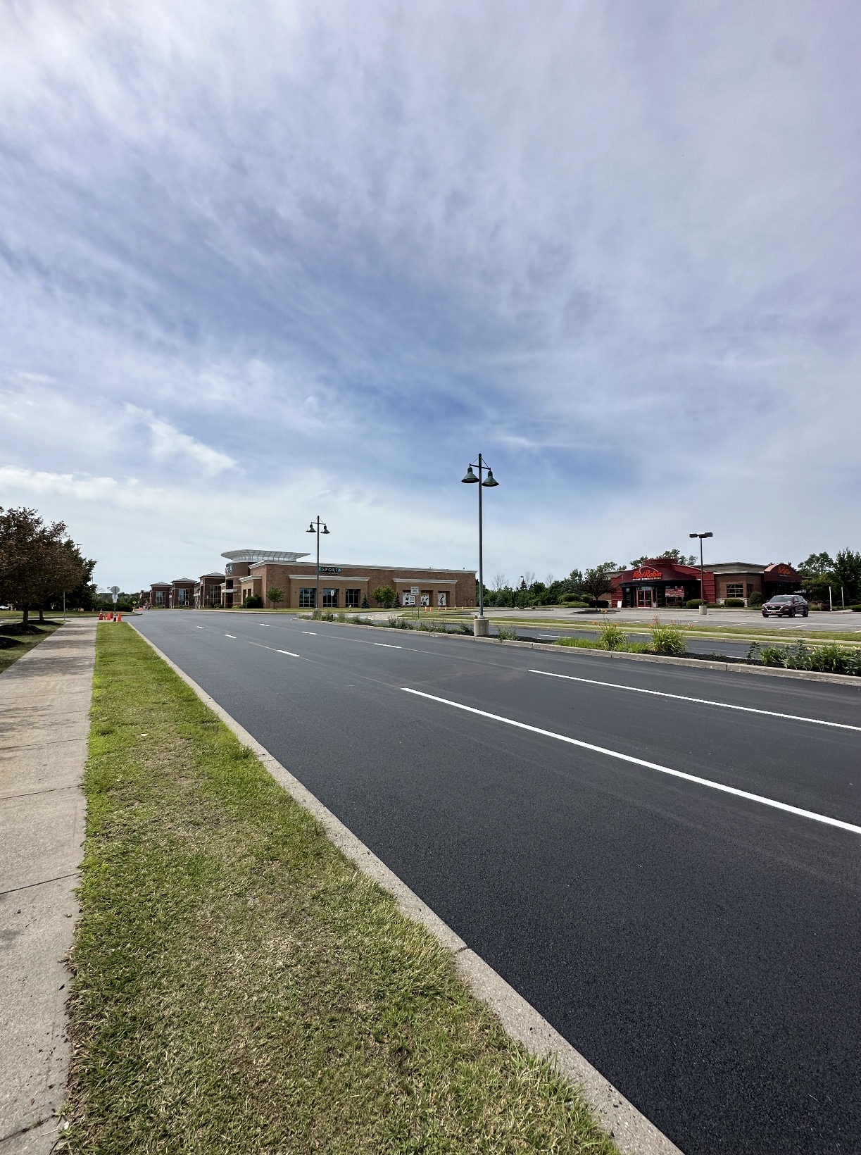 Freshly paved and striped roadway at a retail plaza