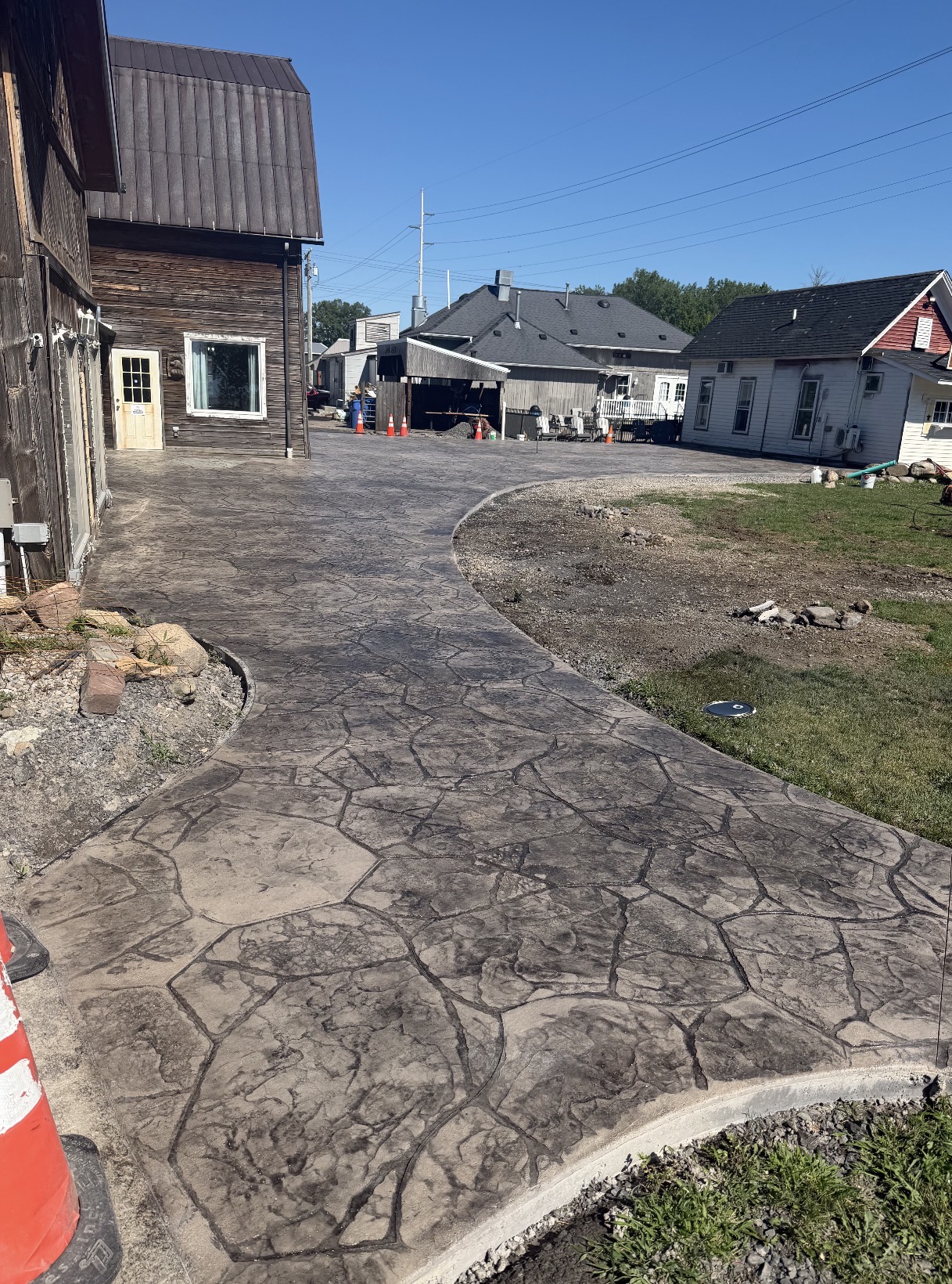 Stamped concrete walkway curving between buildings