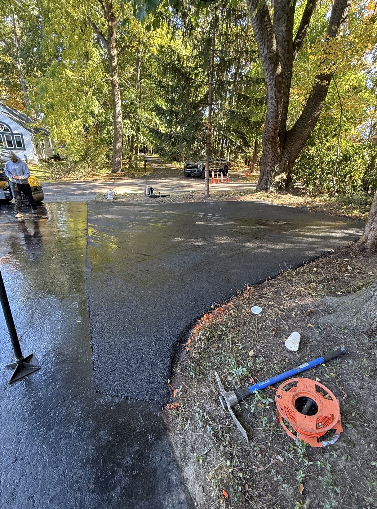 Fresh asphalt driveway apron tied into an existing drive