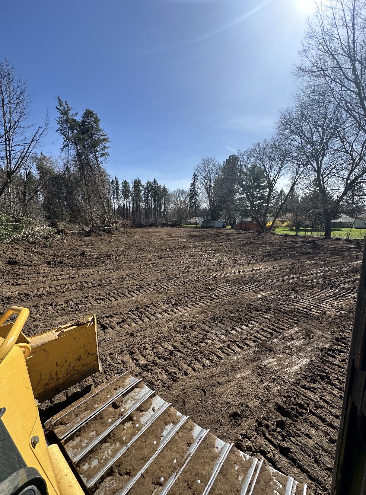 Tracked dozer leveling a cleared residential lot
