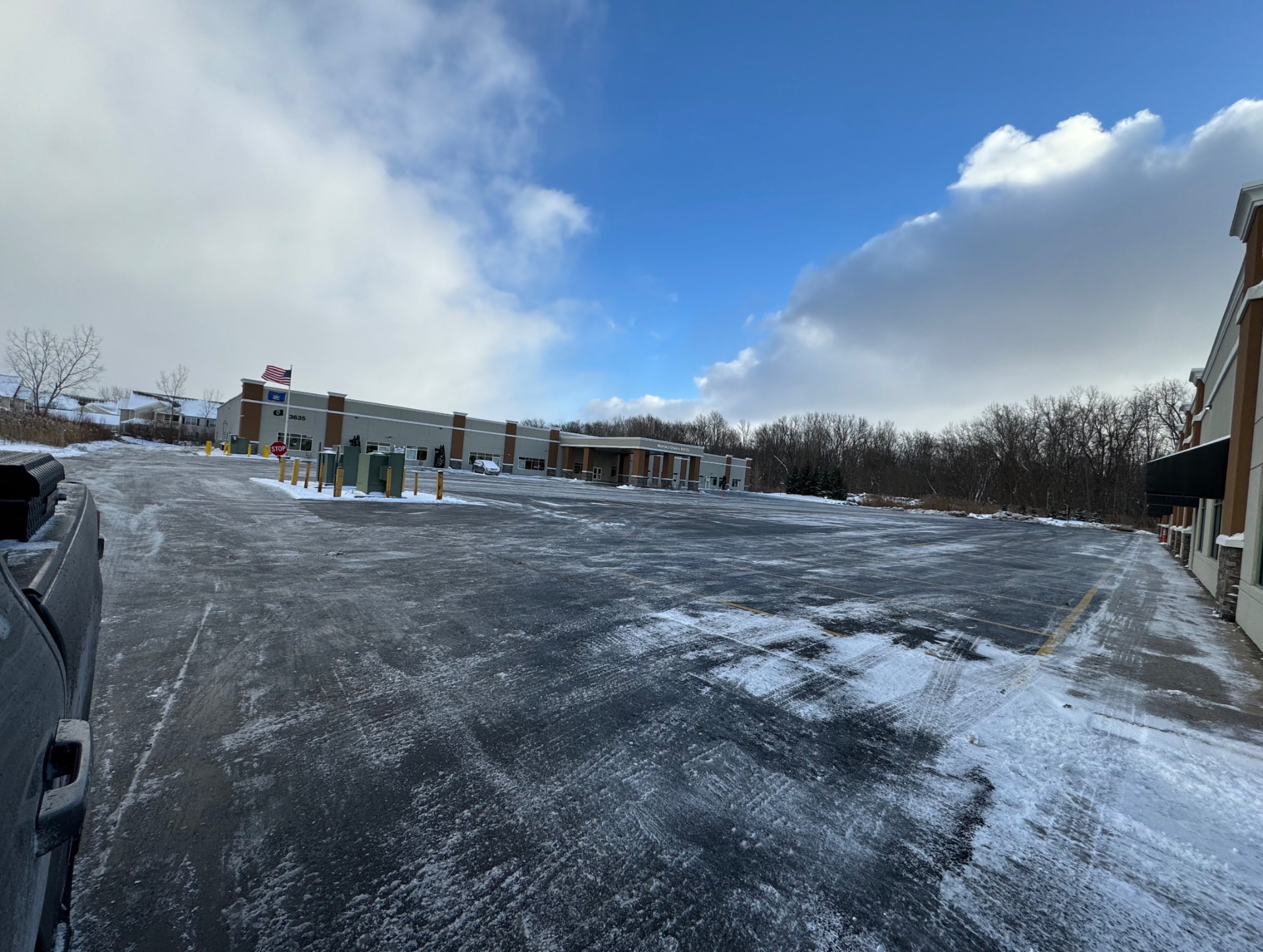 Large commercial plaza parking lot cleared after a snowfall